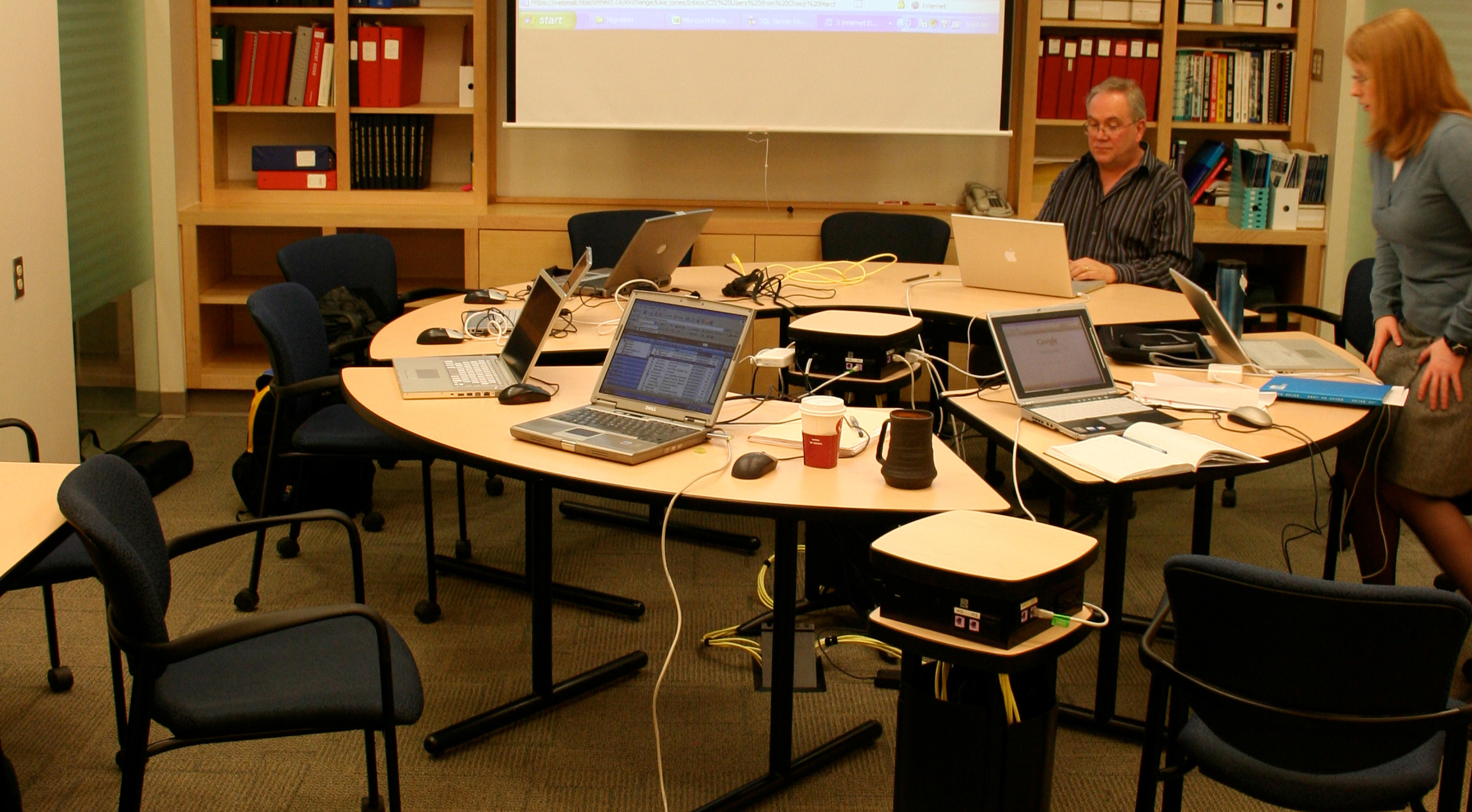 First installation of Elentra  in 2008 (then Entrada) at the University of Calgary, showing desks with multiple laptops set up.