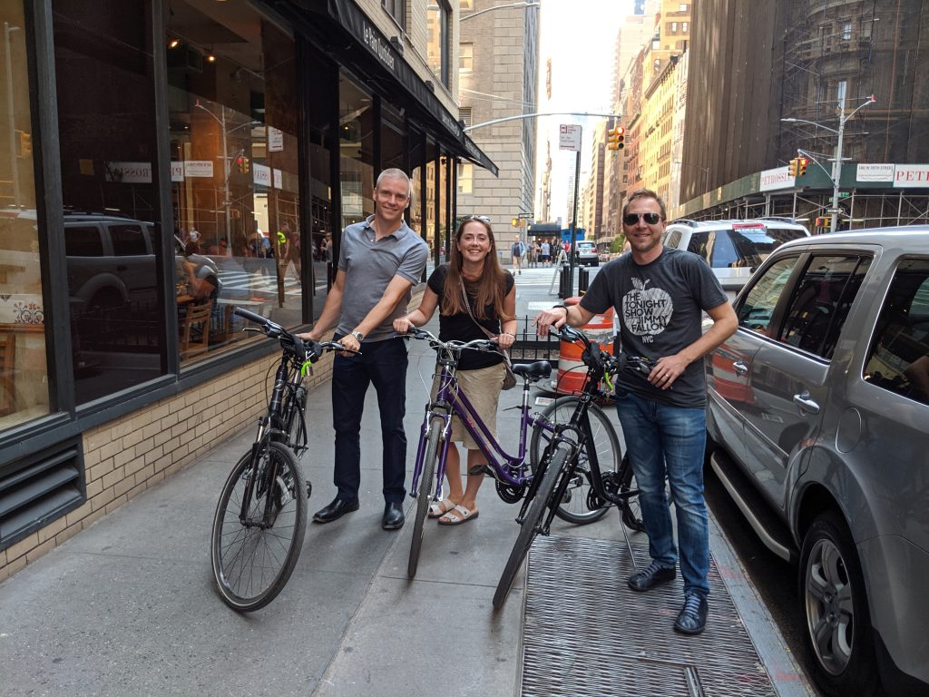 Three consortium members with bikes during a break at the 2019 Elentra Engage Conference.